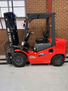 Red Heli Diesel Forklift against a brick wall